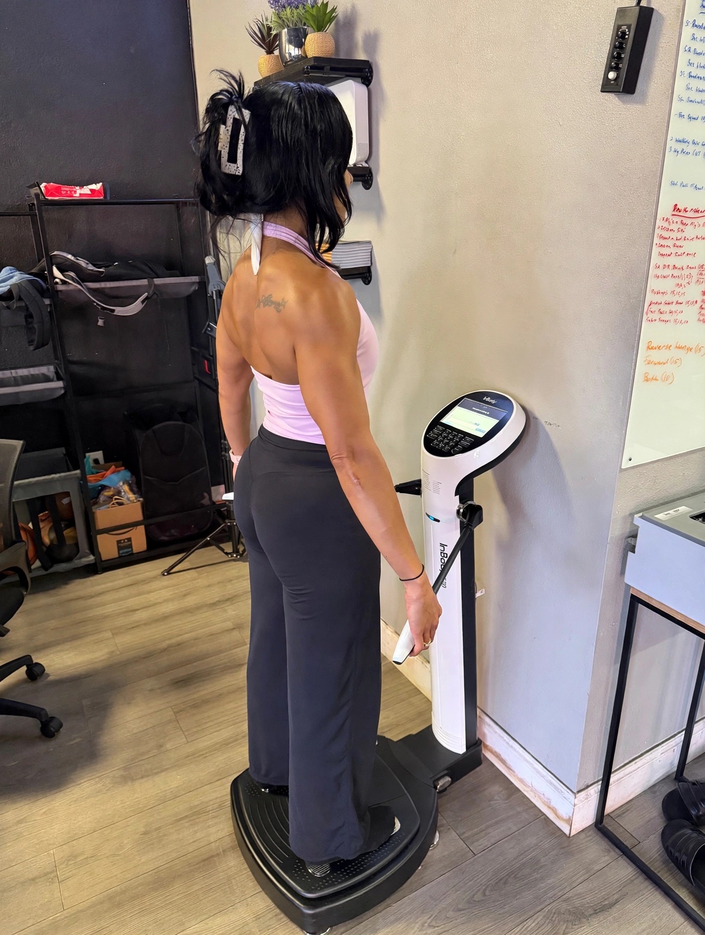 Client taking an InBody body composition scan at Look Who's Fit